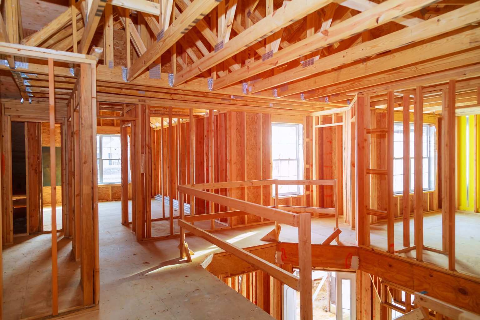 Interior wood framing and roof trusses of a new home under construction